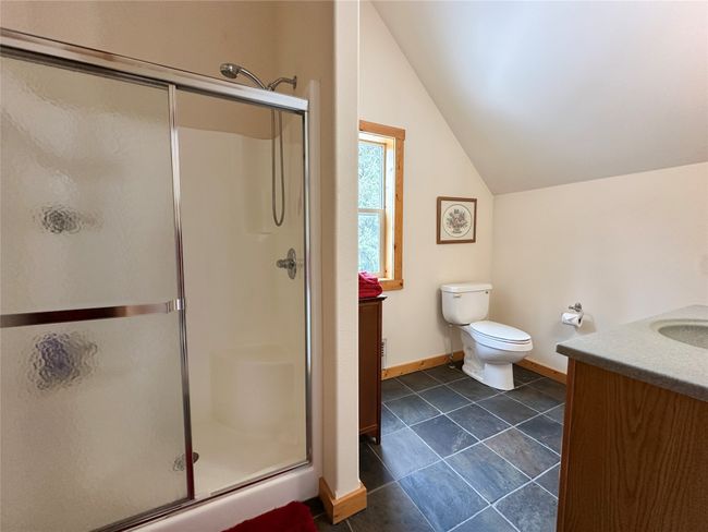 Full bathroom with vanity, a shower stall, baseboards, and lofted ceiling, suite upstairs | Image 32
