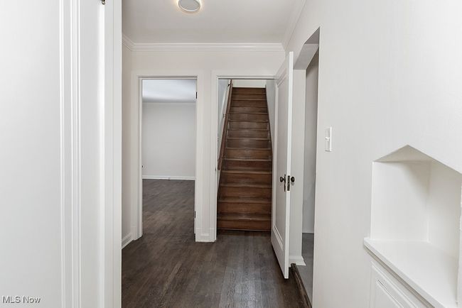 Hallway with dark wood-type flooring and ornamental molding | Image 28