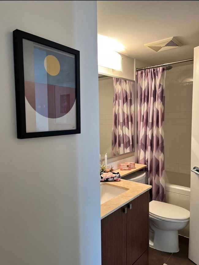 Bathroom with visible vents, toilet, shower / tub combo with curtain, vanity, and tile patterned floors | Image 16