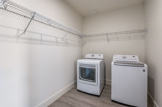 Laundry area with washing machine and clothes dryer and wood finished floors | Image 22