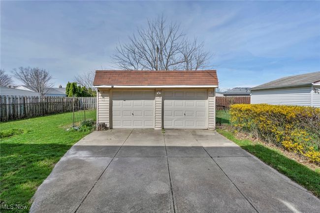 Detached garage featuring fence | Image 7