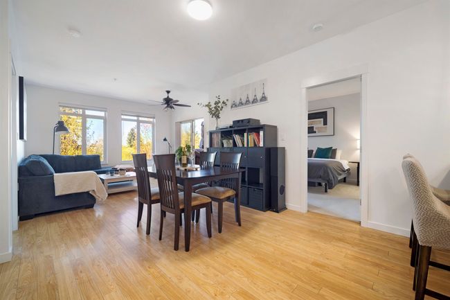 Dining space featuring light wood-type flooring, baseboards, and ceiling fan | Image 9