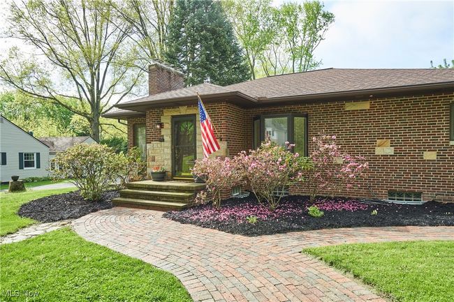 View of front of house with a chimney, brick siding, a front lawn, and roof with shingles | Image 29
