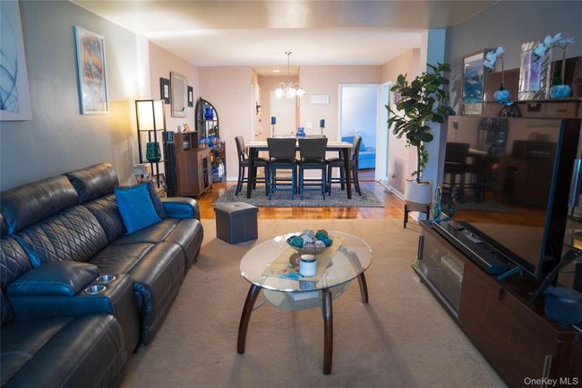 Living room featuring a chandelier and wood finished floors | Image 6
