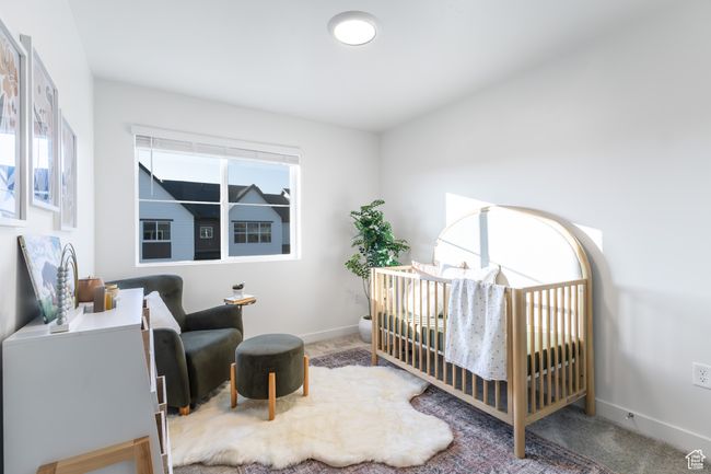 Carpeted bedroom featuring baseboards and a crib | Image 30