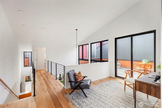 Upstairs, you'll discover an additional two bedrooms, a full bath, access to your roof deck, and a bonus flex space, providing ample room for relaxation, privacy, and versatile living. | Image 17