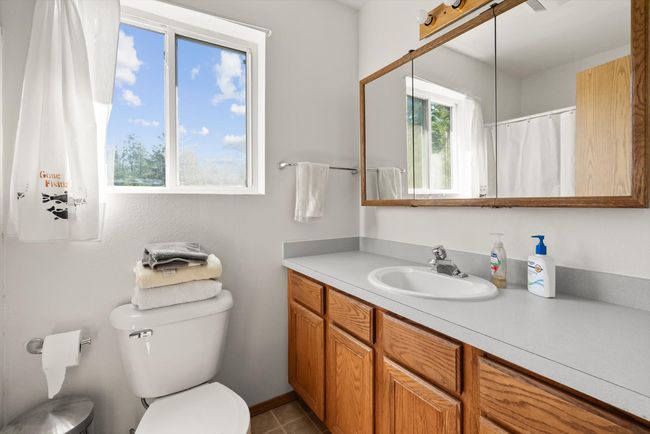 Full bath featuring toilet, healthy amount of natural light, and vanity | Image 25