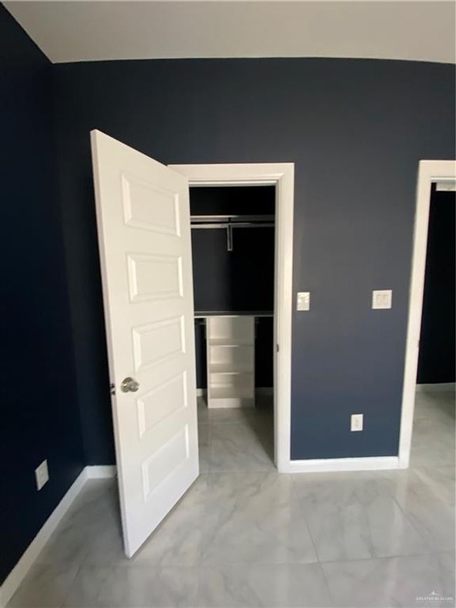 Unfurnished bedroom with light marble finish floors and a closet | Image 14