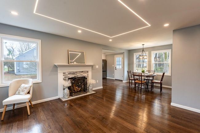 Living area featuring a stone fireplace, baseboards, recessed lighting, and dark wood finished floors | Image 34