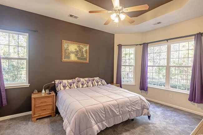 Carpeted bedroom featuring ceiling fan | Image 25