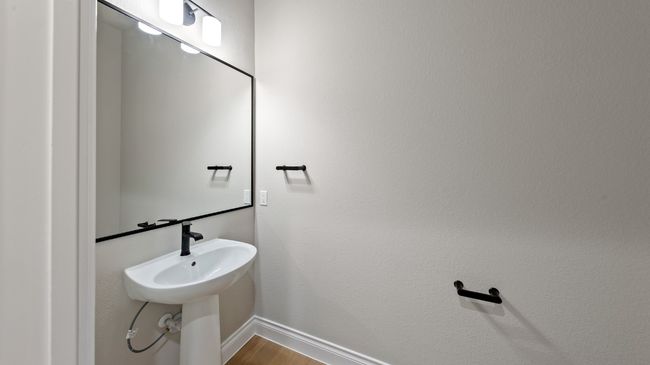 Bathroom with wood finished floors and baseboards | Image 34