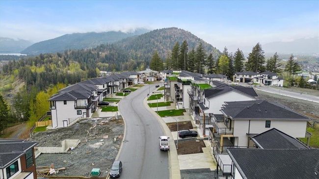 View of mountain backdrop featuring nearby suburban area and a heavily wooded area | Image 19