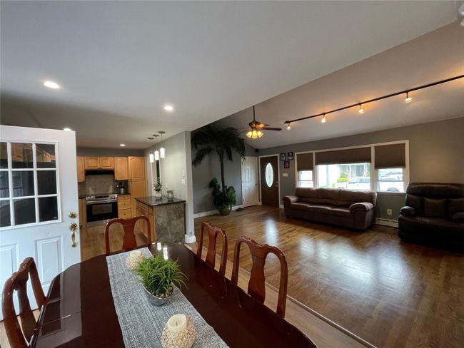 Dining room featuring baseboards, baseboard heating, wood finished floors, ceiling fan, and recessed lighting | Image 11