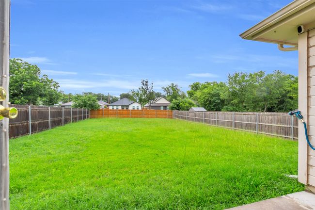 View of fenced backyard | Image 15