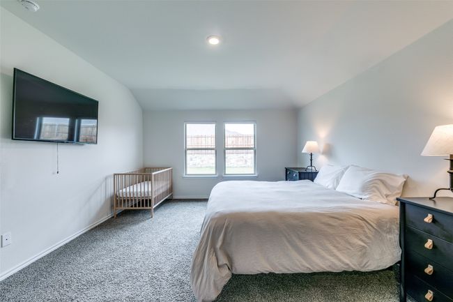 Carpeted bedroom featuring vaulted ceiling | Image 12