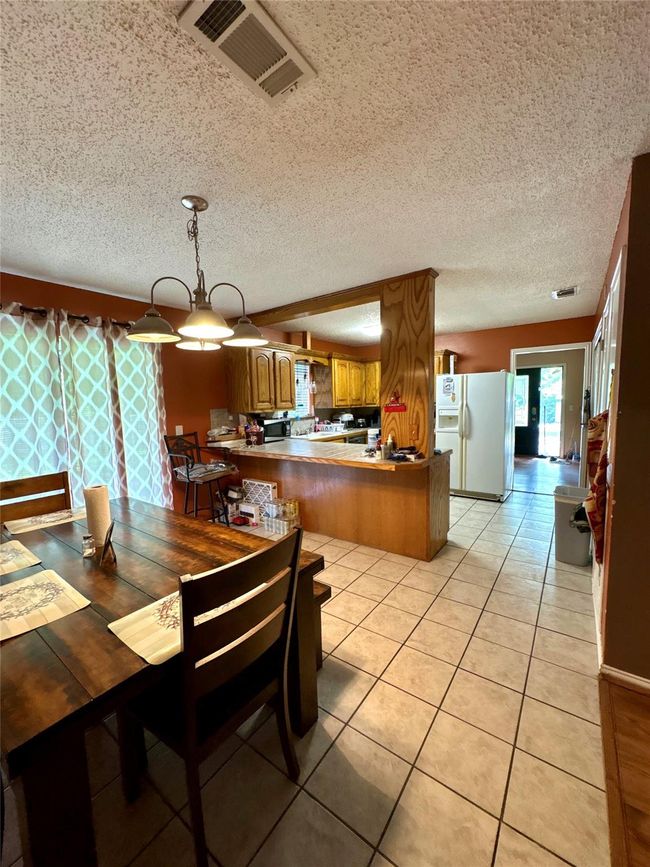 Kitchen with a breakfast bar | Image 17