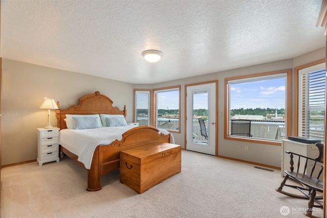 Main floor primary bedroom with ensuite bath, walk in closet and deck with those views! | Image 21