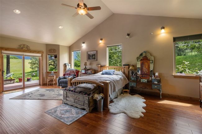 Bedroom with access to exterior, high vaulted ceiling, hardwood / wood-style flooring, recessed lighting, and baseboards | Image 36