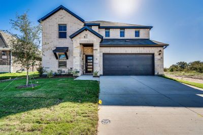 View of front of house featuring a front yard and a garage | Image 1