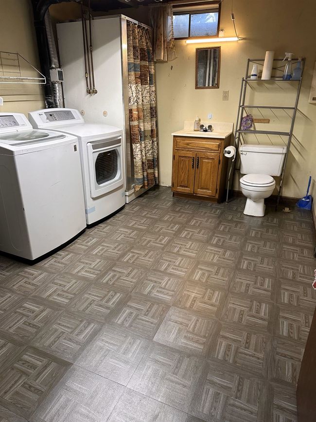 Clothes washing area featuring a sink, independent washer and dryer, and laundry area | Image 10
