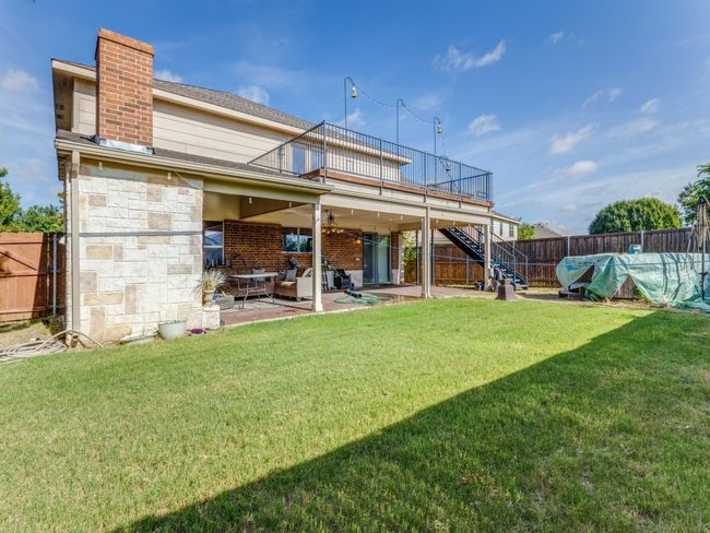 Back of property with stairway, a fenced backyard, a patio, and a chimney | Image 14