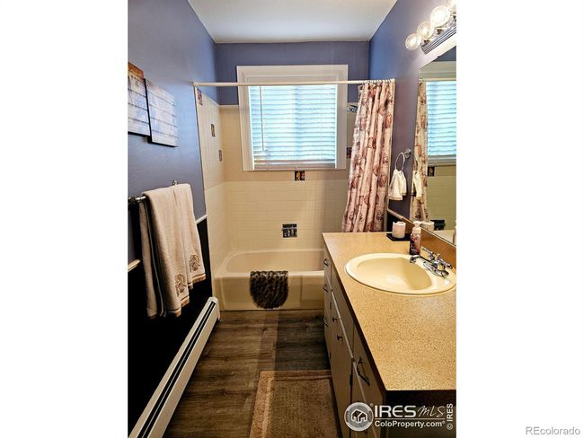 Main level full bathroom with access from hall and primary bedroom | Image 12