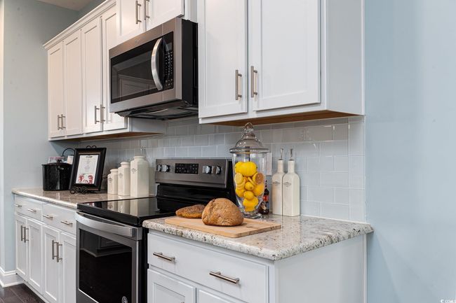 Kitchen with a center island with sink, stainless steel appliances, and a sink | Image 7