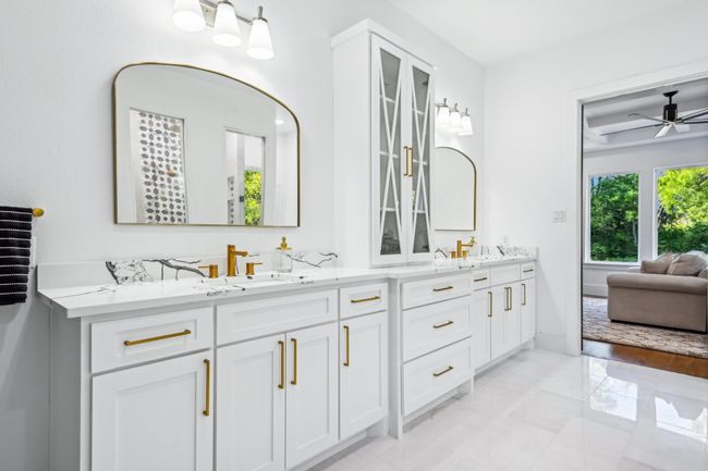 Full bath with marble tiled flooring, double vanity, and ceiling fan | Image 18