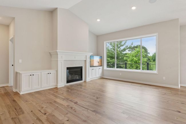 Custom built ins, gas fireplace surrounded in tile and a wall of windows brings the outdoors in | Image 9