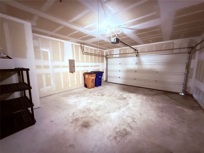 Garage with electric panel and a garage door opener | Image 14