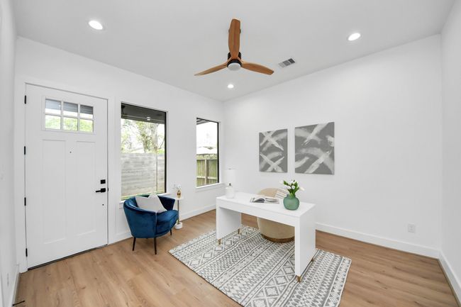 Third bedroom features large windows, ceiling fan, and recessed lighting. This backdoor leads you to a side yard and covered patio coming off of the secondary bedroom. | Image 23