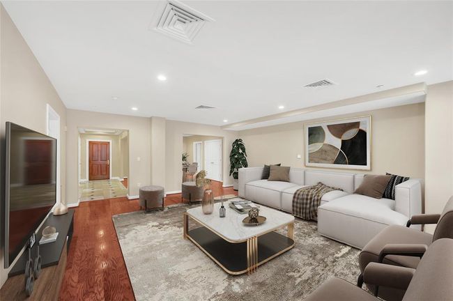Living Room looking through to front door down Entry Hallway on left and into Dining Room on Right. Kitchen is open door to right in Dining Room. Door on near left leads to Primary Suite. PHOTO VIRTUALLY STAGED. | Image 4