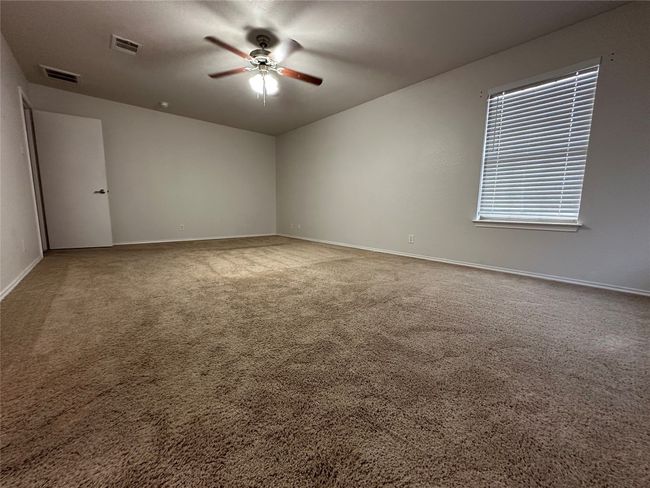 Spare room featuring a ceiling fan and carpet flooring | Image 30
