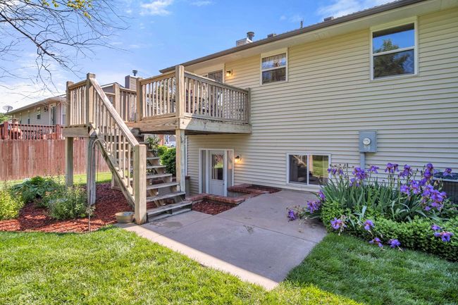 Rear view of property with stairway, a wooden deck, central air condition unit, and a patio area | Image 32
