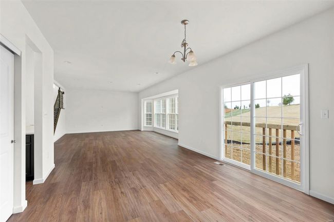Unfurnished living room with hardwood / wood-style floors and a chandelier | Image 19
