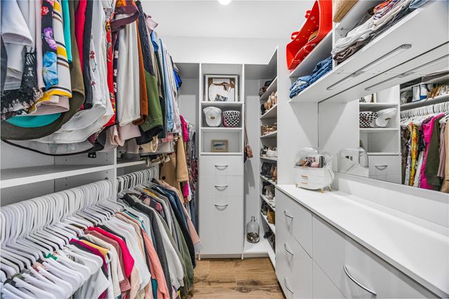 Spacious closet with light wood-type flooring | Image 26