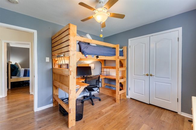 Bedroom featuring an office area, wood finished floors, baseboards, and a closet | Image 20