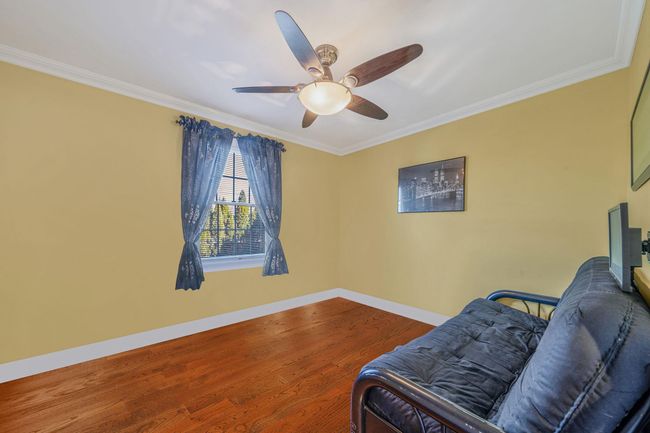 Living area featuring ornamental molding, baseboards, ceiling fan, and wood finished floors | Image 13
