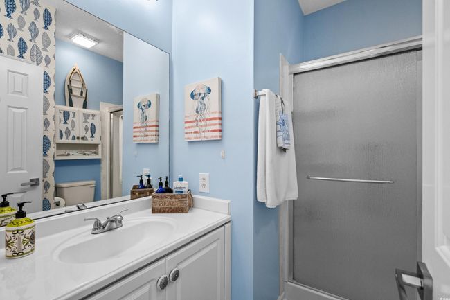Bathroom featuring a stall shower, toilet, and vanity | Image 28
