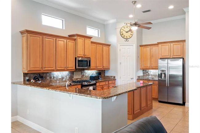 Spacious breakfast bar and plenty of lighting. | Image 10