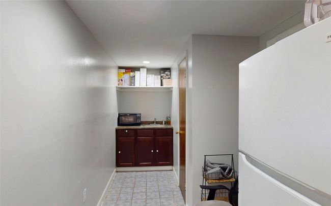 Hallway featuring baseboards and a sink | Image 38