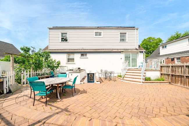 Rear view of property with a patio area, outdoor dining area, a deck, and stucco siding | Image 6
