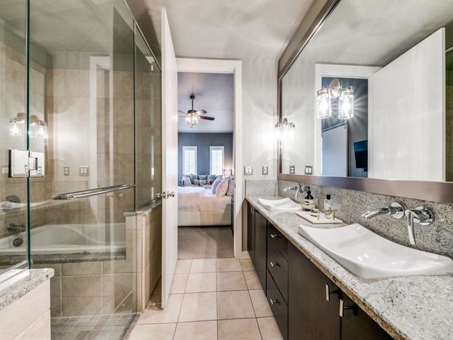 Bathroom with connected bathroom, tile patterned floors, tiled shower, ceiling fan, and double vanity | Image 7