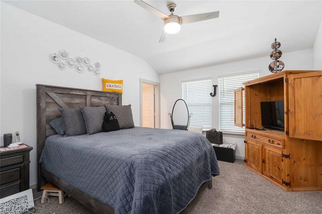 Spacious primary bedroom with tray ceiling, neutral palette, and ample natural light for a peaceful retreat. | Image 11