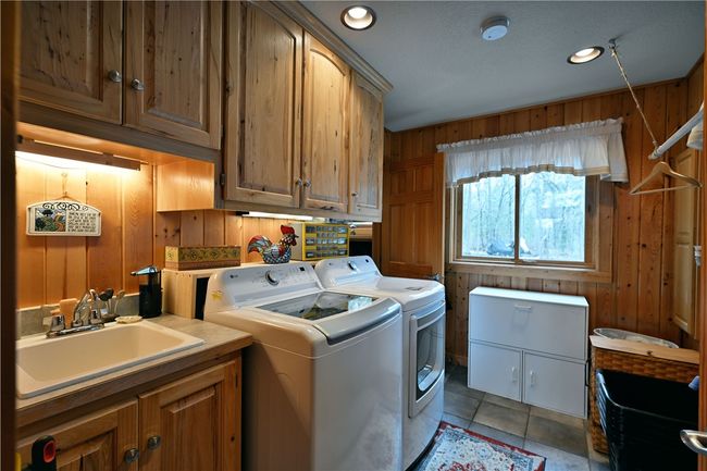 Main floor laundry which connects to master walk-in closet for great convenience. | Image 27