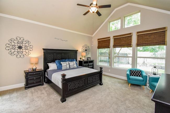 The owner's retreat has a vaulted ceiling with a wall of windows and ceiling fan! | Image 23