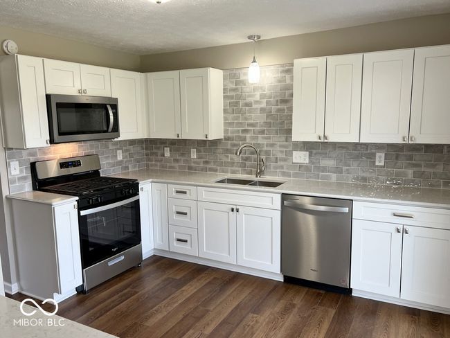 Completely updated kitchen with Granite countertops, brand new appliances, cabinets, fixtures, and tile backsplash | Image 14