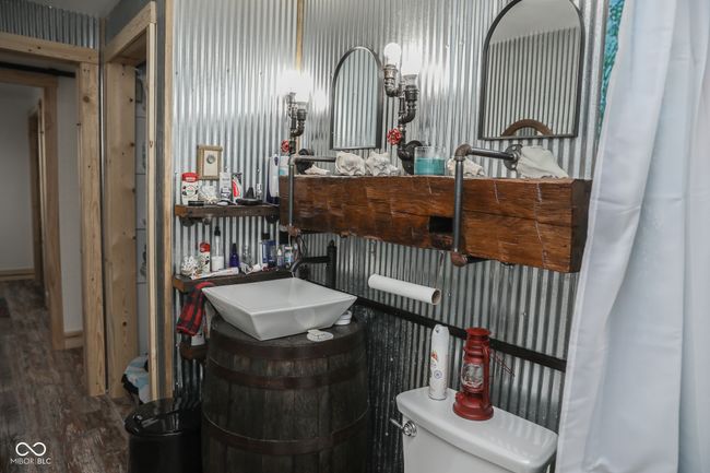 bathroom with toilet, wood finished floors, and vanity | Image 7