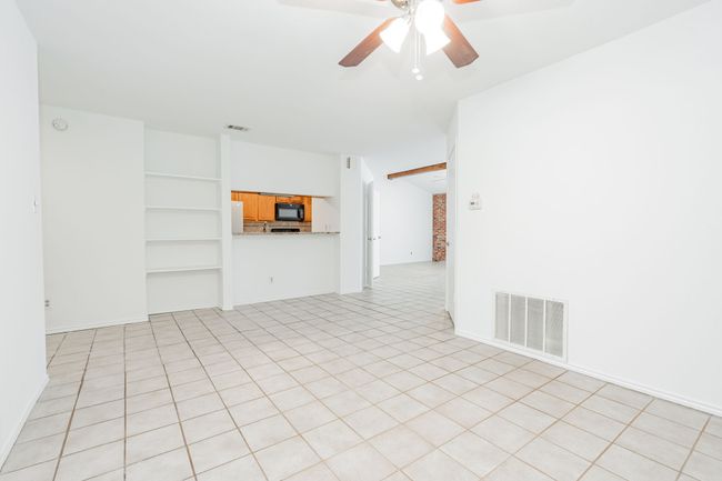 Unfurnished room with vaulted ceiling with beams, a ceiling fan, and visible vents | Image 31