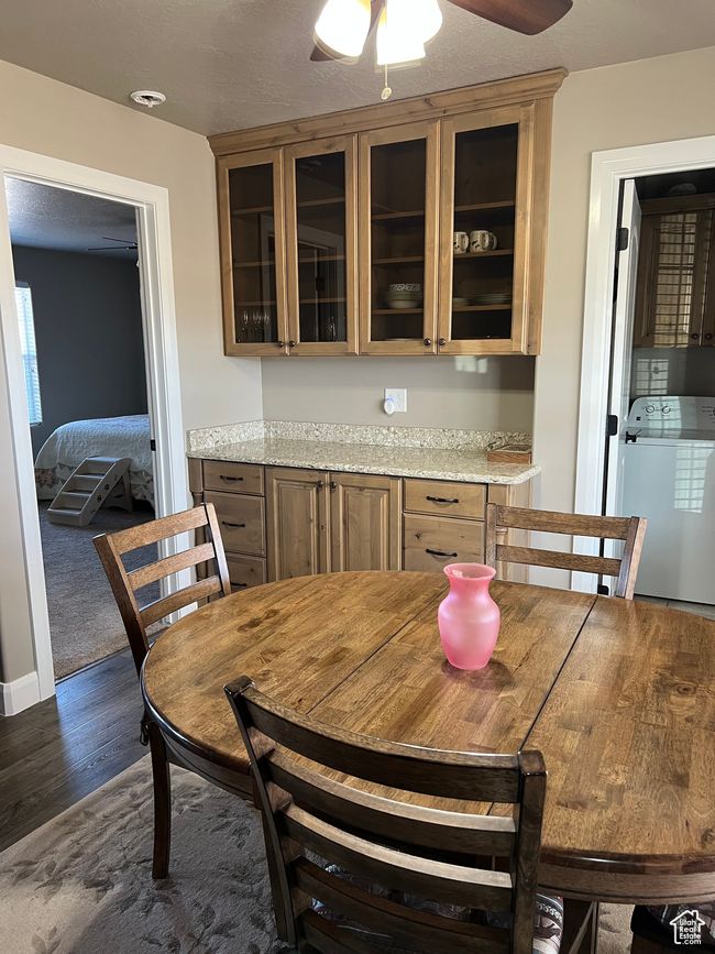 Dining space with washer / dryer, dark wood-style floors, and a ceiling fan | Image 27